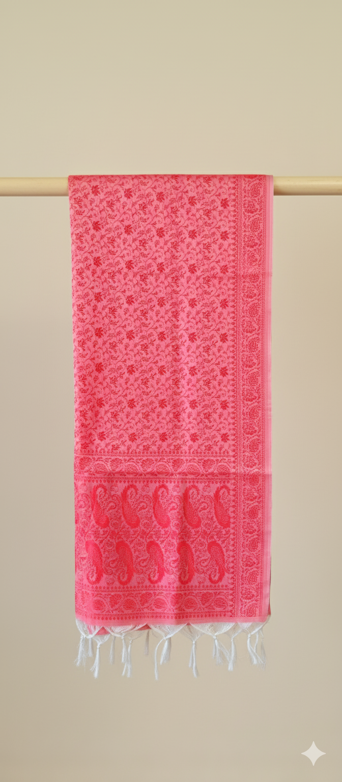 Red patterned stole with white fringe on a beige background